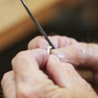 A student uses a torch on a silver ring