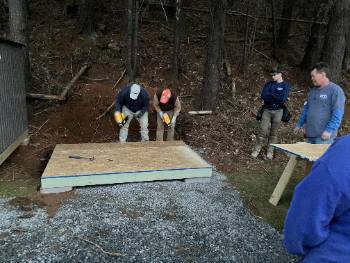 students using nail guns to build a shed platform