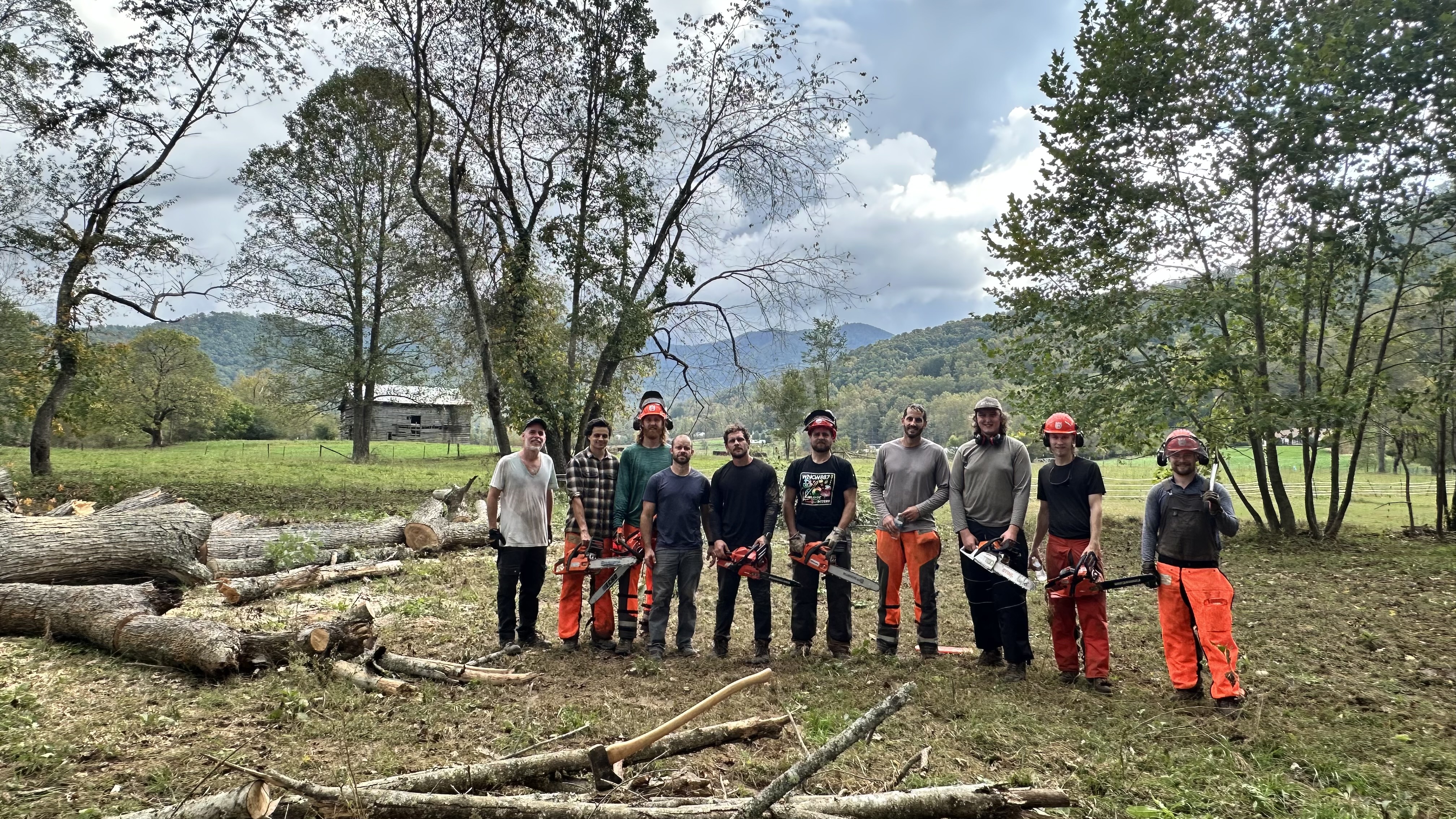 Forestry students in a field helping to clear debris