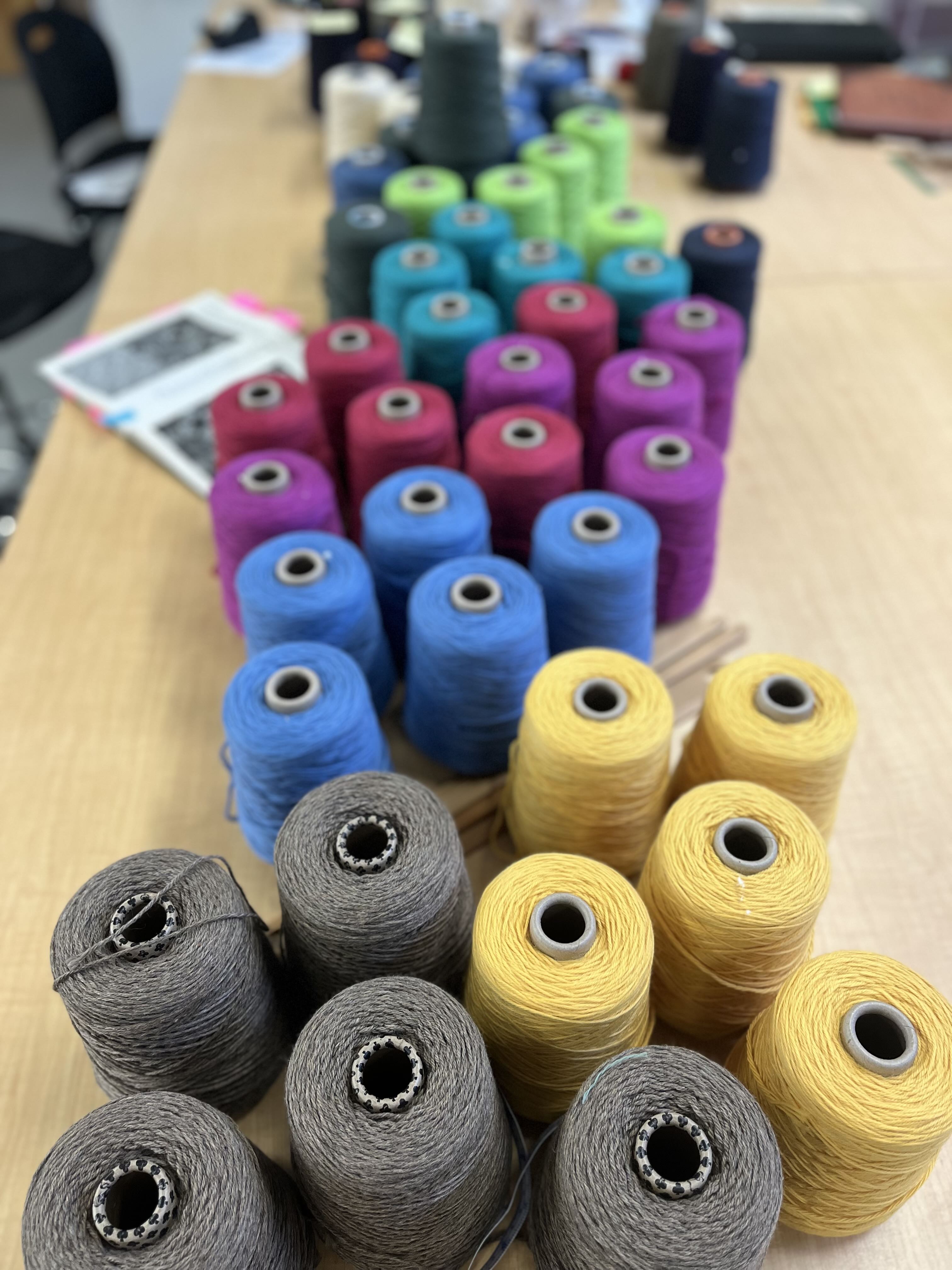 spools of colored wool on a table