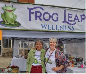 Kate and Dale under Frog Leap Wellness sign at their event booth